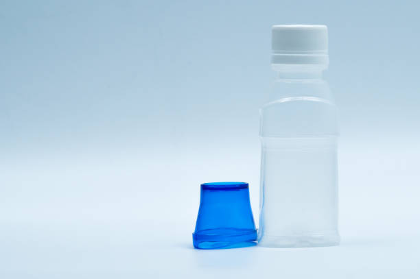 istock Sterile eye lotion in white plastic bottle with blue eyebath and copy space and blank label. Eye wash after contact pollution environment or after swimming in chlorine contaminate pool. 903510410