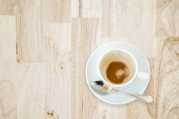 istock leftover coffee in white ceramic cup with spoon on wooden desk 903516898