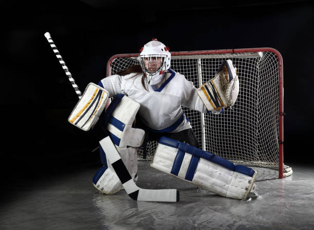 istock Young female hockey goalie makes a save. 903522738