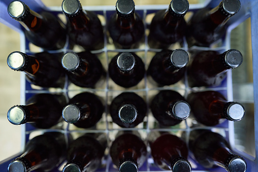 Directly above view of beer bottles in plastic crate, close-up shot
