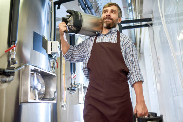 istock Bearded Brewer with Beer Kegs 903527874