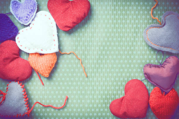 istock Colorful knitted hearts on a green background 903537106