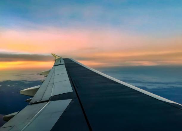 istock aerial sunrise over airplane wing in flight 903540514