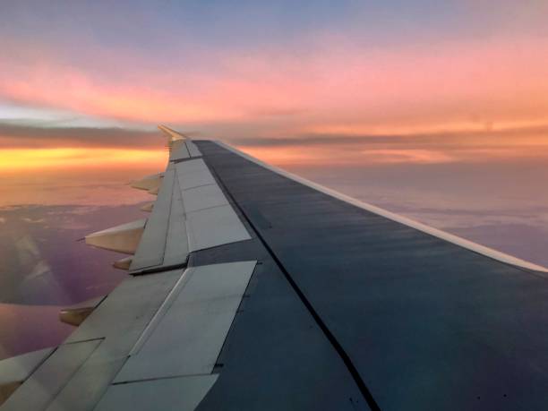 istock aerial sunrise over airplane wing in flight 903540536