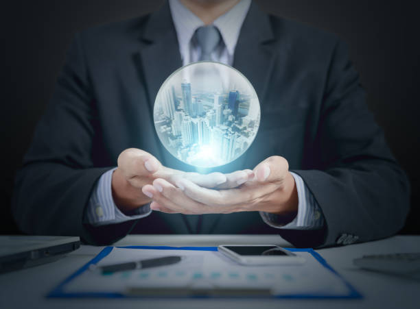 istock businessman hand hold crystal ball with building inside 903545202
