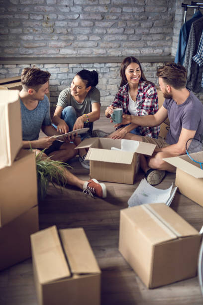 istock Group of happy friends communicating while relocating into new apartment. 903545480