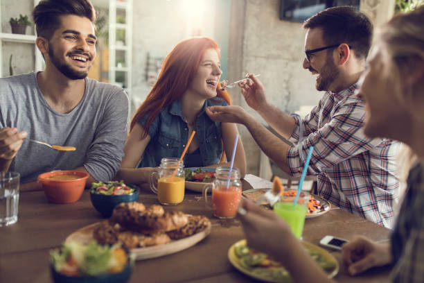 istock Happy couple having fun while eating lunch with their friends in a restaurant. 903548150