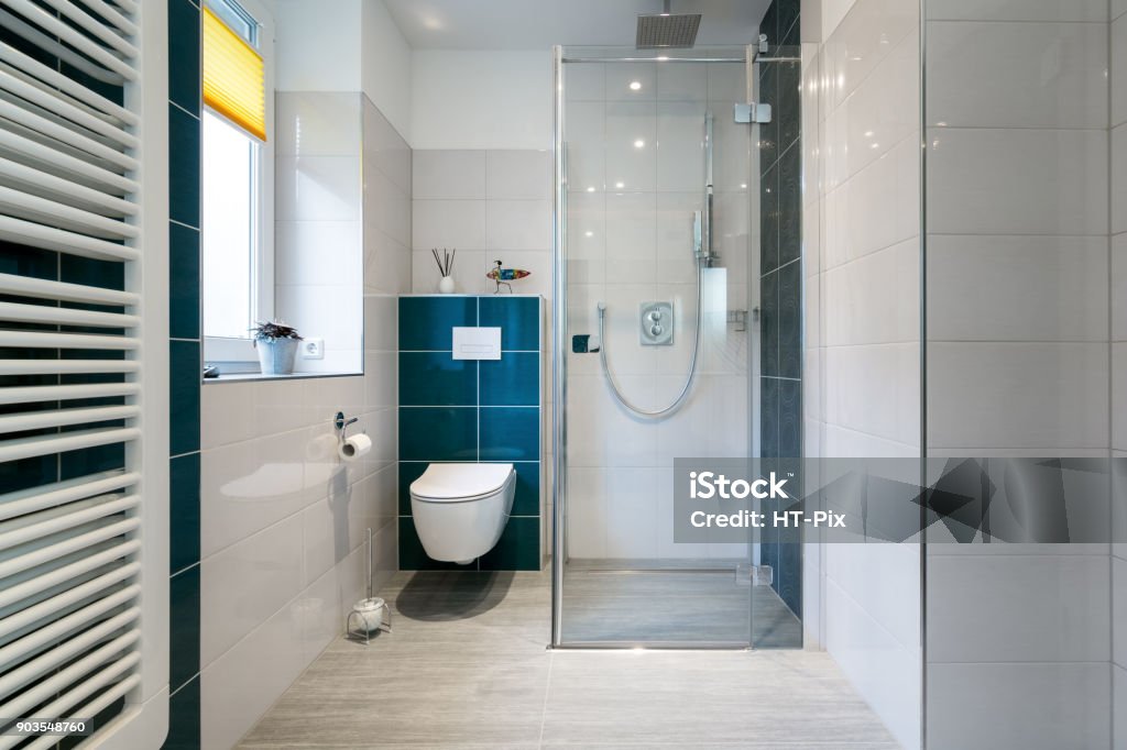 Luxury Bathroom with walk in Glass Shower - Horizontal shot of a luxury bathroom with large, walk-in shower. Horizontal shot of a luxury bathroom with large, walk-in shower. Blue and white tiles Shower Stock Photo
