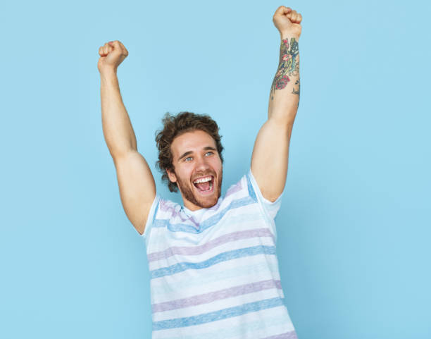 istock Victorious casual man on blue 903552188