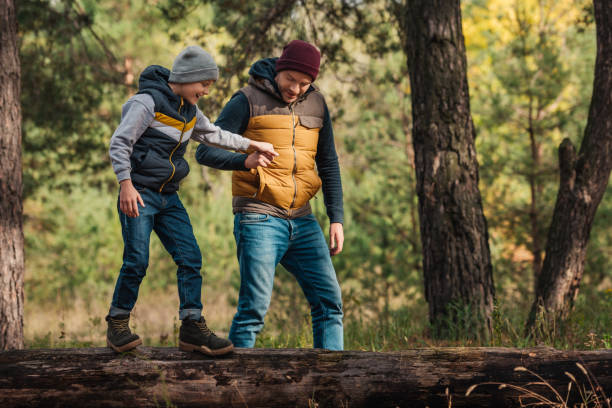 istock father and son walking in forest 903555068