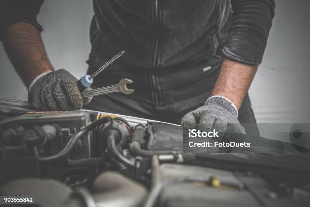 Car Mechanic Looking To The Engine In The Garage Car Motor Repair Problems And Solutions Concept Stock Photo - Download Image Now