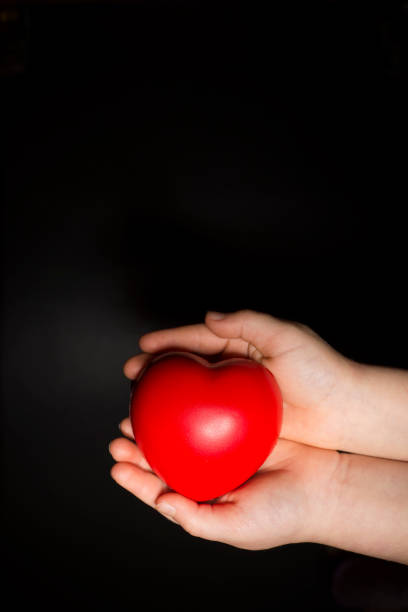 istock Little girl holding a heart 903556336