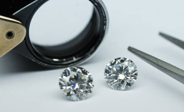 istock Diamonds with tweezers and loup 903560378