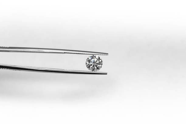 istock Diamond in tweezers 903560900