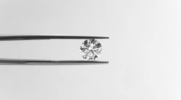 istock Diamond in tweezers 903561256