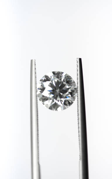 istock Diamond in tweezers 903561512