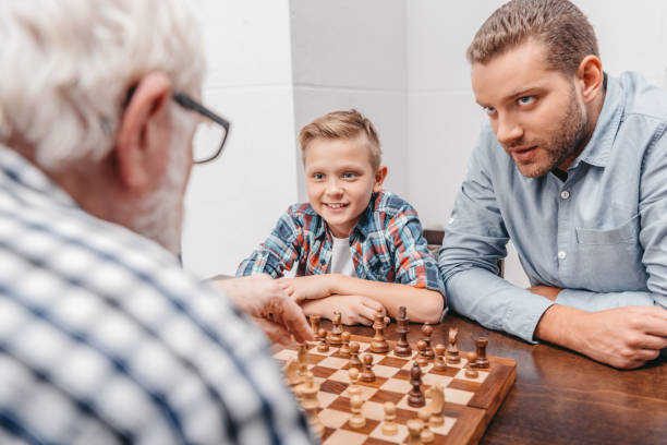 istock Father and grandfather playing chess 903561796