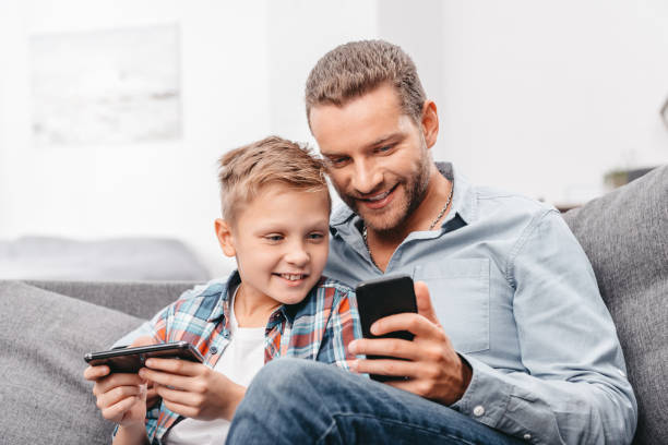istock Father and son with smartphone 903562262