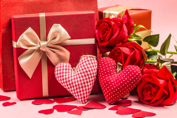 istock Rose and present gift on wooden background/ Valentines day background 903568234