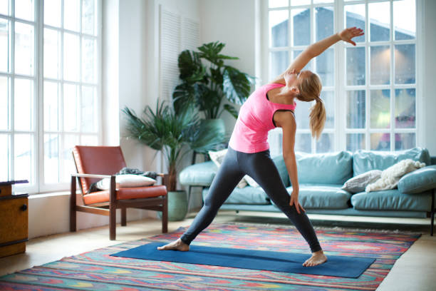 yoga classes - stretching women attractive female indoors imagens e fotografias de stock