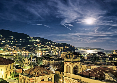 Detail of Rapallo, Italy at night with full moon.