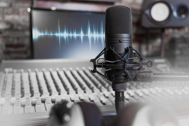 istock condenser microphone on recording studio background. music, singing, recording concept 903577056