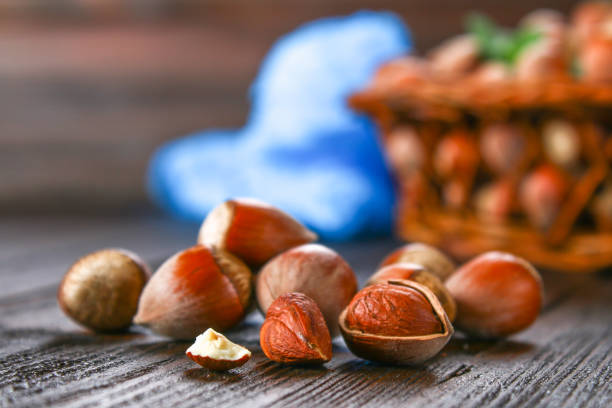 istock Walnut hazelnuts in a wicker basket on a brown wooden table. 903577618