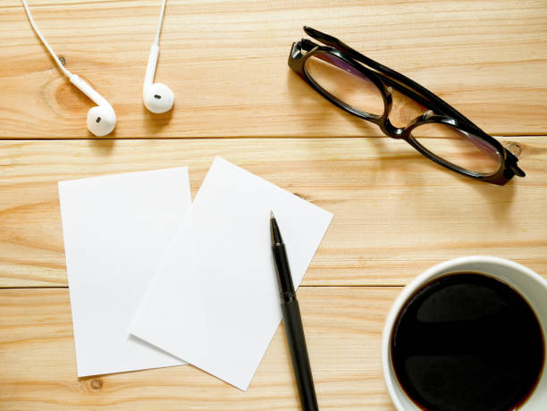 istock Blank notepad, pen, glasses, black coffee and earphones 903578220