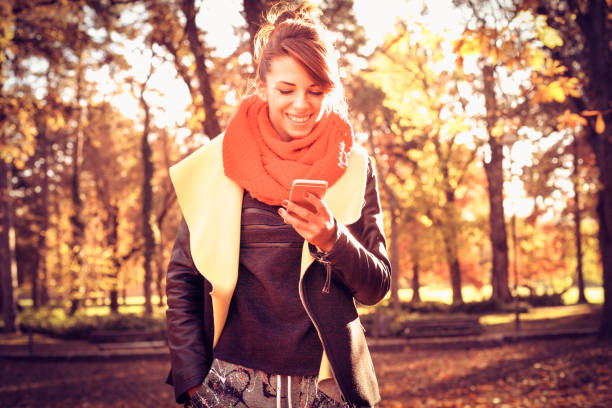 istock Young woman in the park using smart phone. 903579152