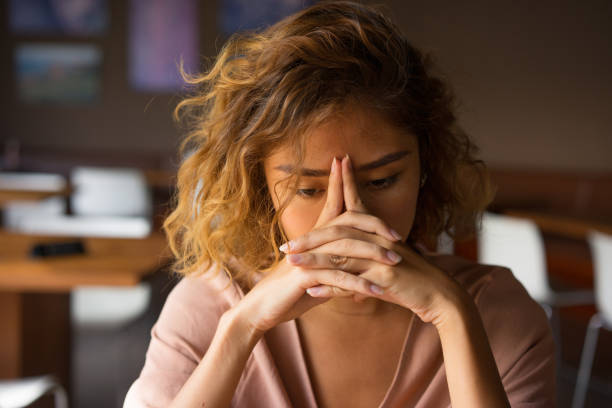 istock Tired Young Woman Leaning Head on Hands 903582010
