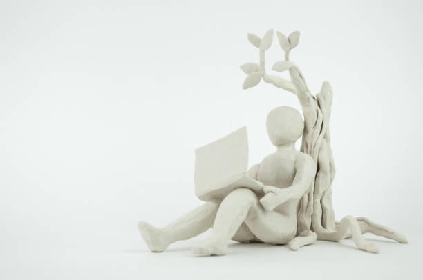 Under the tree freelance work Under the tree freelance work with laptop, plasticine model clay sculpture stock pictures, royalty-free photos & images