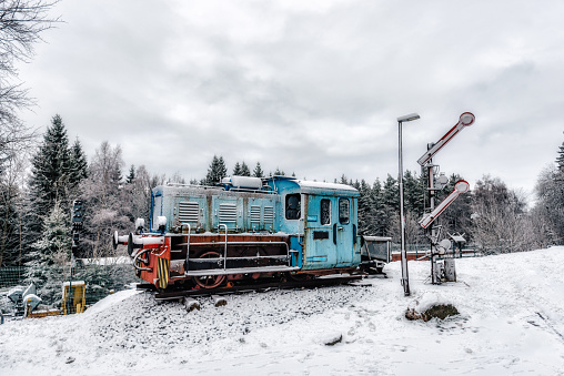 old blue railroad engine resting in the snowy landscape of Thuringian Forest