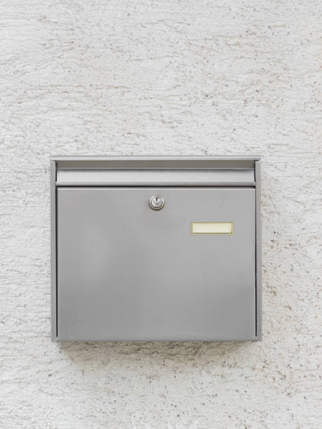 A silver mailbox on the wall stock photo