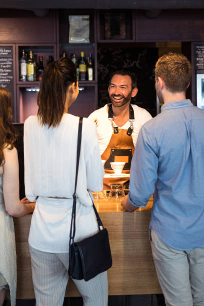 istock Young customers gently served in a modern cafe 903598042