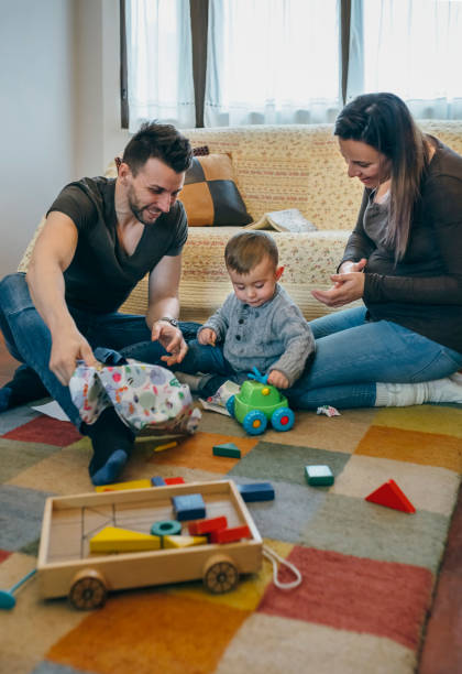 istock Parents with their little son opening a gift 903600856