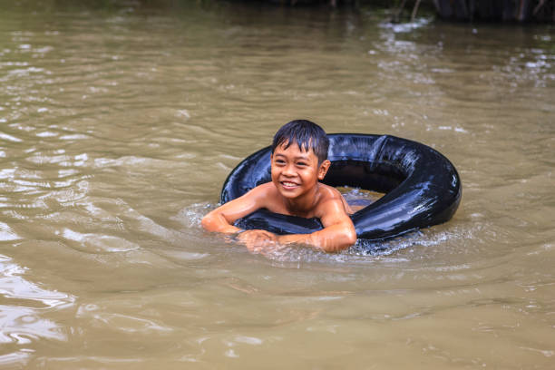 istock Vietnamese little boy bathing in Mekong River Delta, Vietnam 903601040