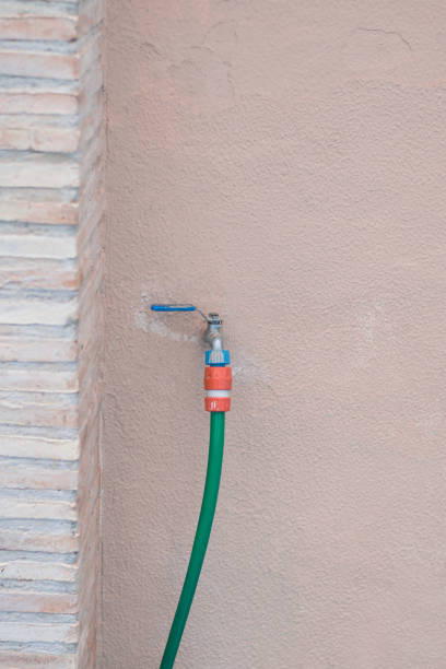 istock Tap and green hose on a wall. 903601742