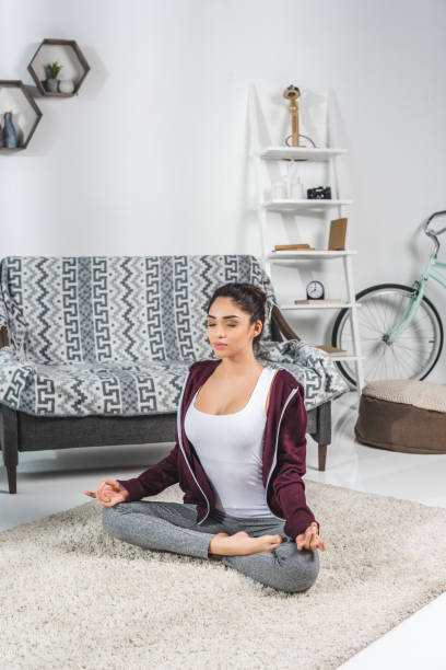 istock girl in yoga pose at home 903604772