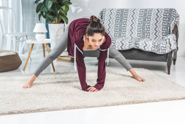 istock girl exercising at home 903604868