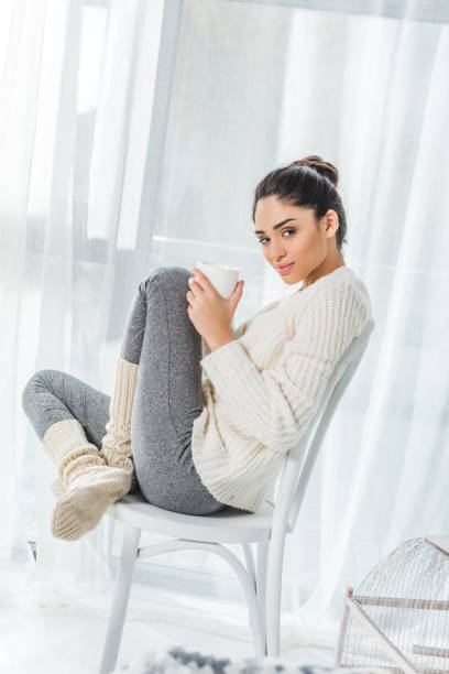 istock girl with cup at home 903607550