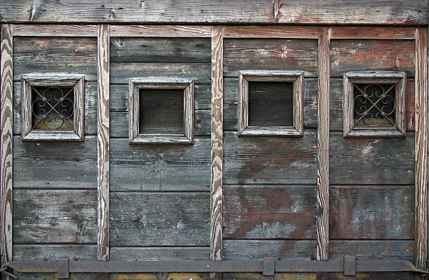 Close-up of a blue peeling paint wall of a vintage carriage.