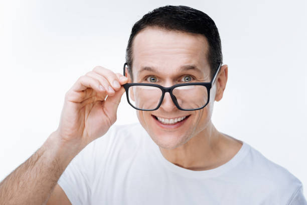 istock Cheerful nice man holding his glasses 903607818