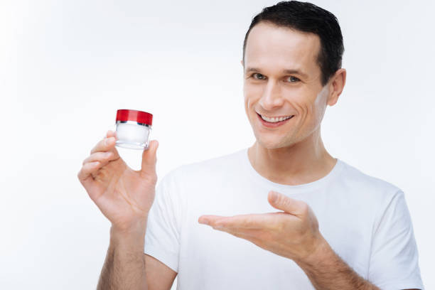 istock Happy handsome man showing cream 903608288