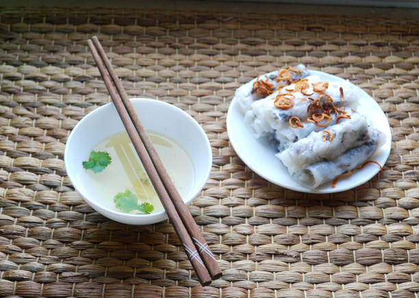 istock Banh cuon-vietnamese steamed rice rolls with minced meat inside accompanied by bowl of fish sauce. 903608352
