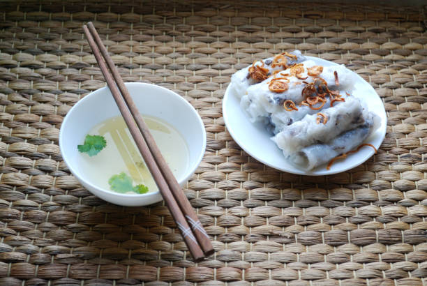 istock Banh cuon-vietnamese steamed rice rolls with minced meat inside accompanied by bowl of fish sauce. 903608364