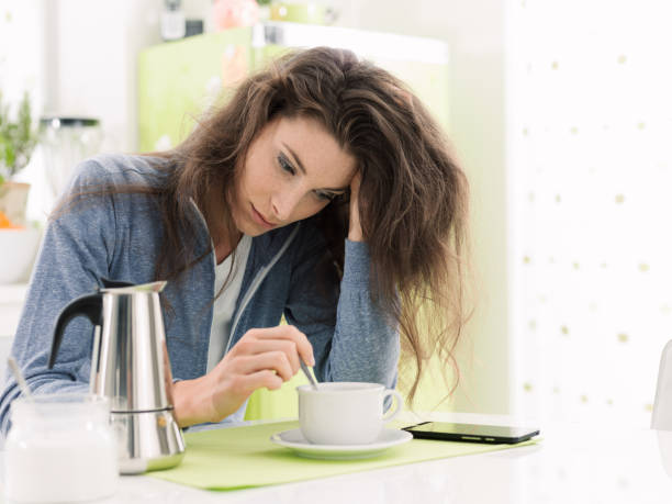 istock Tired woman having breakfast at home 903608512