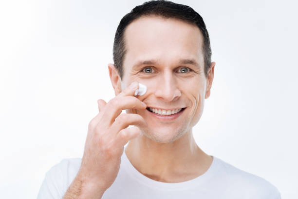 istock Happy joyful man caring about his skin 903609832