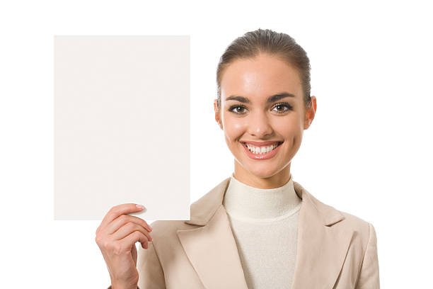 Cheerful businesswoman standing with blank signboard, isolated on white stock photo