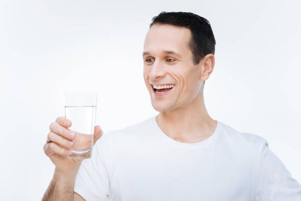 istock Cheerful delighted man preparing to drink water 903612726