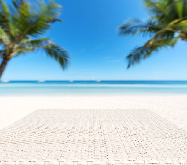 istock Wood weave table surface and tropical beach background 903613618